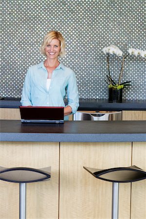 expensive kitchen - Portrait of smiling woman using laptop in kitchen Stock Photo - Premium Royalty-Free, Code: 693-05552953