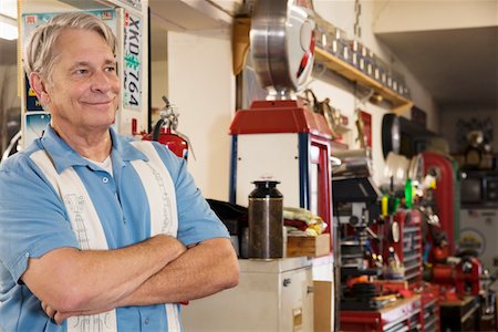 Smiling senior man in automobile workshop Stock Photo - Premium Royalty-Free, Code: 693-05553152