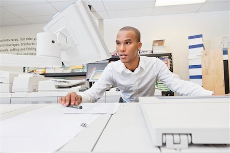 printer of man at work - Man looking at visual screen Stock Photo - Premium Royalty-Free, Code: 693-05794032