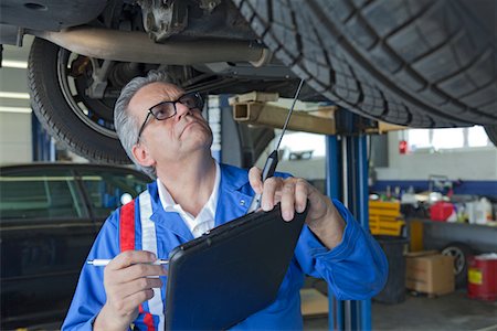 Mechanic analyzing car engine at auto repair shop Foto de stock - Sin royalties Premium, Código: 693-05794051