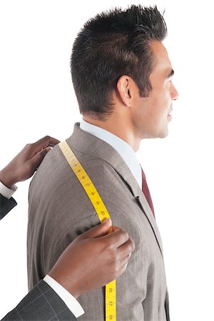 Tailor measuring across upper back from shoulder to shoulder of customer Stock Photo - Premium Royalty-Free, Code: 693-05794074