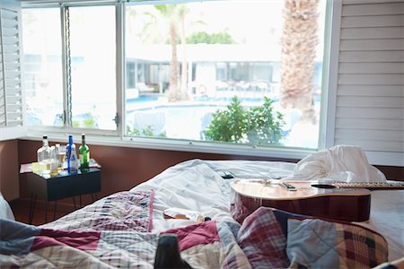 Interior of bedroom with guitar on bed Stock Photo - Premium Royalty-Free, Code: 693-05794190