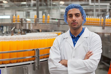 factory workers hairnet - Portrait of confident factory worker standing with arms crossed Stock Photo - Premium Royalty-Free, Code: 693-05794238