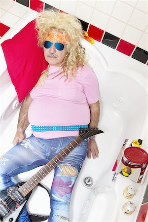 sunglasses and bandana - Guitarist lying in bathtub Stock Photo - Premium Royalty-Free, Code: 693-05794299