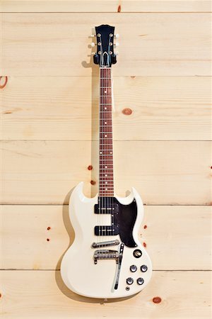 White guitar on wood grain wall Foto de stock - Sin royalties Premium, Código: 693-05794338