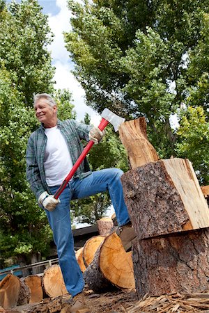 Low angle view of man holding an axe Stock Photo - Premium Royalty-Free, Code: 693-05794382