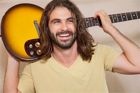 simsearch:693-05794451,k - Happy man holding guitar on back of his shoulders Stock Photo - Premium Royalty-Free, Code: 693-05794458