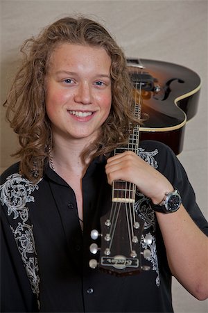 Portrait of smiling young musician with guitar Stock Photo - Premium Royalty-Free, Code: 693-05794461