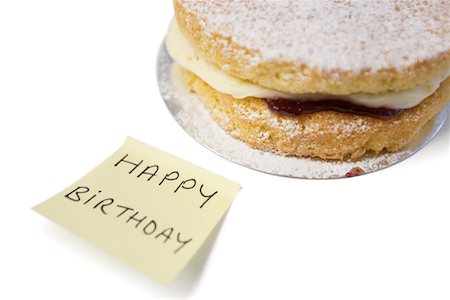 sponge - Delicious cake slice with 'happy birthday' notepaper Stock Photo - Premium Royalty-Free, Code: 693-05794520