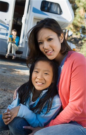 Sisters sitting outside RV in campground Stock Photo - Premium Royalty-Free, Code: 693-06014019