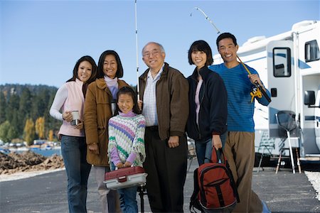 Three-generation family holding fishing poles by RV at lake Stock Photo - Premium Royalty-Free, Code: 693-06014021