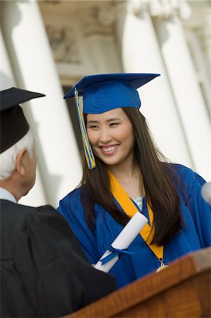 picture of person receiving diploma - Graduate Receiving Diploma outside university Stock Photo - Premium Royalty-Free, Code: 693-06014172