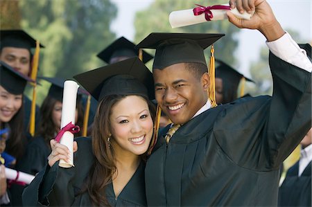 simsearch:693-06014222,k - Graduates hoisting diplomas outside Stock Photo - Premium Royalty-Free, Code: 693-06014181