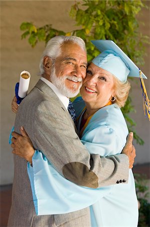 Senior graduate hugging husband outside Stock Photo - Premium Royalty-Free, Code: 693-06014221