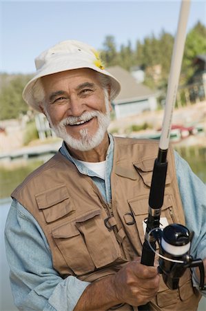 portrait fisherman older - Middle-aged man fishing, smiling, (portrait) Stock Photo - Premium Royalty-Free, Code: 693-06014323