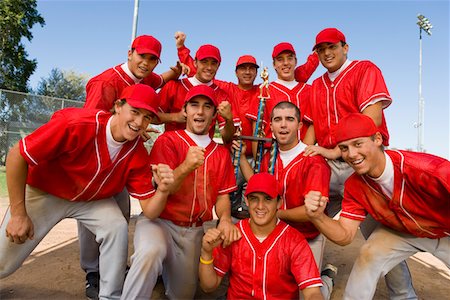 Baseball team-mates holding trophy on field Stock Photo - Premium Royalty-Free, Code: 693-06014394