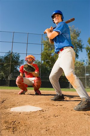 standing catcher - Baseball player swinging baseball bat, catcher crouching in background Stock Photo - Premium Royalty-Free, Code: 693-06014392