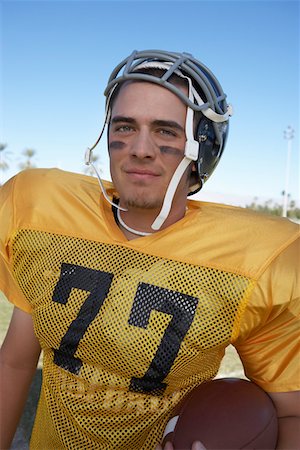 football faces paintings pictures - Player Holding Football on field, portrait, (portrait) Stock Photo - Premium Royalty-Free, Code: 693-06014421