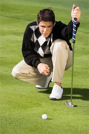 Golfer lining up putt Stock Photo - Premium Royalty-Free, Code: 693-06014465