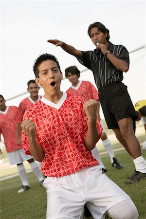 football kneeling - Soccer player celebrating, portrait Stock Photo - Premium Royalty-Free, Code: 693-06014497