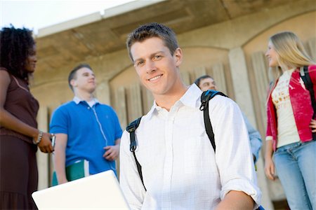 Male student using laptop outdoors, (portrait) Stock Photo - Premium Royalty-Free, Code: 693-06014813