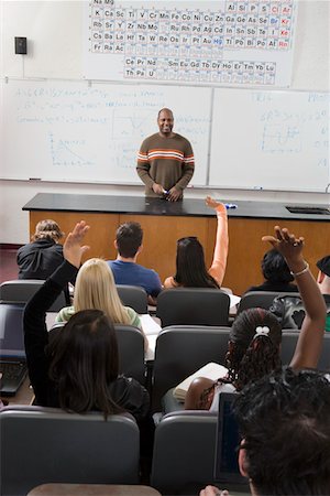 students with hands raised in classroom with female teacher - University students raising hands in class Stock Photo - Premium Royalty-Free, Code: 693-06014833