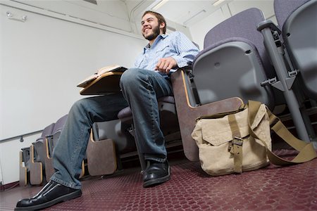 excited college student with books - Male University student sitting in lecture hall Stock Photo - Premium Royalty-Free, Code: 693-06014841