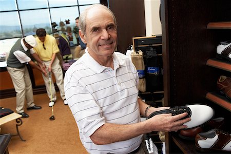 shopping basket - Senior Man in Golf Shop shopping for golf shoes Foto de stock - Sin royalties Premium, Código: 693-06014866