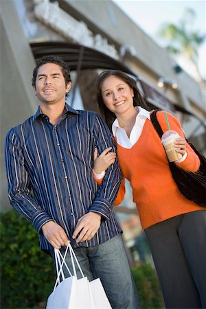 simsearch:694-03319744,k - Young couple with shopping bags, portrait Photographie de stock - Premium Libres de Droits, Code: 693-06014862