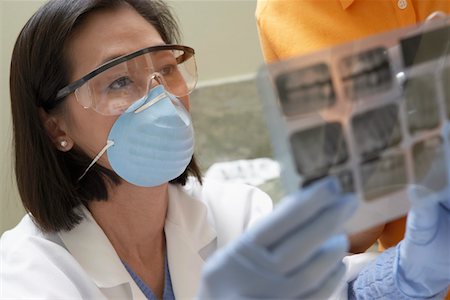 simsearch:693-06014951,k - Female dentist and patient examining X-rays, (close-up) Stock Photo - Premium Royalty-Free, Code: 693-06014940