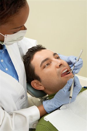 simsearch:693-06014951,k - Dentist examining male patient, (close-up) Stock Photo - Premium Royalty-Free, Code: 693-06014959