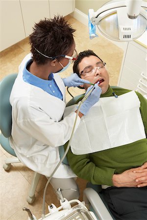 dentist cleans - Dentist examining male patient Stock Photo - Premium Royalty-Free, Code: 693-06014960