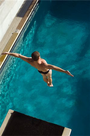 Swimmer jumping into swimming pool Stock Photo - Premium Royalty-Free, Code: 693-06015095
