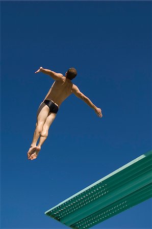 Swimmer diving into swimming pool Stock Photo - Premium Royalty-Free, Code: 693-06015101
