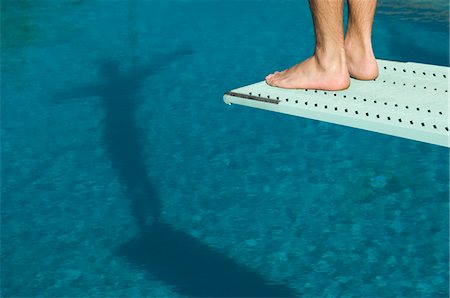 Male swimmer standing on diving board Stock Photo - Premium Royalty-Free, Code: 693-06015103