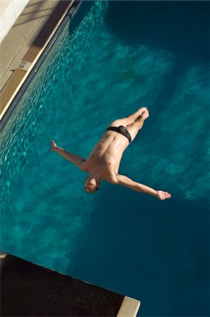 Male swimmer diving into swimming pool Stock Photo - Premium Royalty-Free, Code: 693-06015134