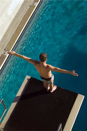 Male swimmer standing on diving board Stock Photo - Premium Royalty-Free, Code: 693-06015133