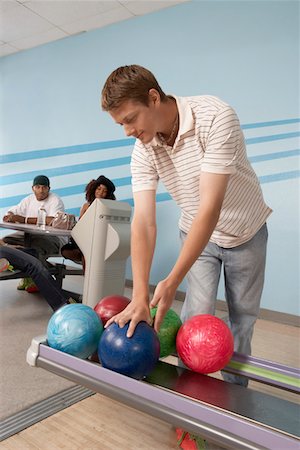 simsearch:693-06015216,k - Young man at bowling alley choosing ball Stock Photo - Premium Royalty-Free, Code: 693-06015196