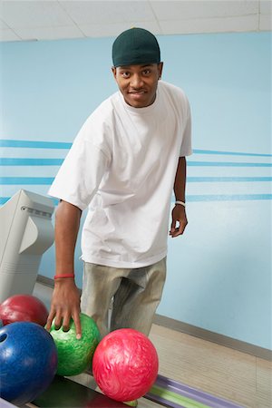 simsearch:693-06015216,k - Young man at bowling alley choosing ball, portrait Stock Photo - Premium Royalty-Free, Code: 693-06015197