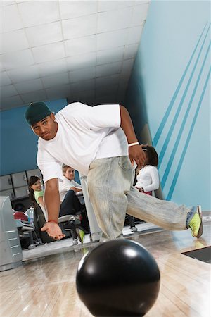 simsearch:693-06015216,k - Young man releasing bowling ball, portrait Stock Photo - Premium Royalty-Free, Code: 693-06015215