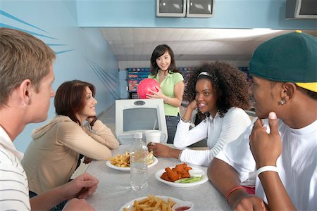 simsearch:693-06015216,k - Group of friends eating at bowling alley Stock Photo - Premium Royalty-Free, Code: 693-06015219