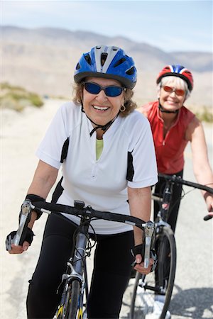 simsearch:693-06015367,k - Two women on bicycle ride, portrait Stock Photo - Premium Royalty-Free, Code: 693-06015362