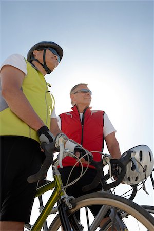 simsearch:693-06015367,k - Two men on bicycle ride, portrait, low angle view Stock Photo - Premium Royalty-Free, Code: 693-06015377