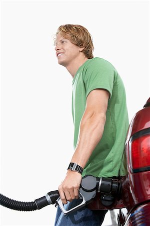 Young man filling car with gasoline Stock Photo - Premium Royalty-Free, Code: 693-06015515