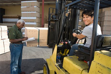 Senior warehouseman and mid-adult forklift truck driver Stock Photo - Premium Royalty-Free, Code: 693-06015590