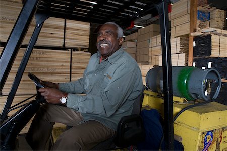 Senior forklift truck driver at warehouse Stock Photo - Premium Royalty-Free, Code: 693-06015606