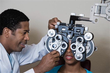 Optometrist examining patient's eyes Foto de stock - Sin royalties Premium, Código: 693-06015876