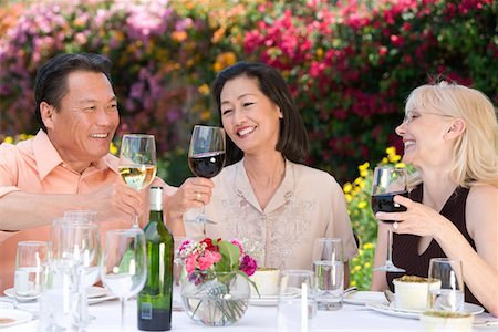 simsearch:693-06015925,k - Three friends toasting at outdoor table Stock Photo - Premium Royalty-Free, Code: 693-06016007