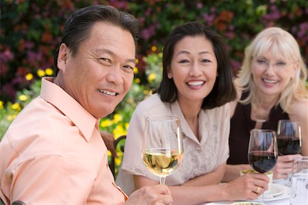 simsearch:693-06015925,k - Three friends drinking wine outdoors, portrait Stock Photo - Premium Royalty-Free, Code: 693-06016008