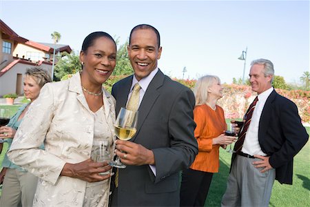 simsearch:693-06015925,k - Couple holding drinks at outdoor party, portrait Stock Photo - Premium Royalty-Free, Code: 693-06016024